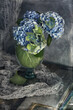 Beautiful hydrangea flowers in a vase on a blue background .Soft focus.
