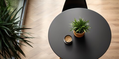 Poster - Round wooden table and black chair indoors, top view