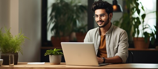 Smiling Indian freelancer working from home office