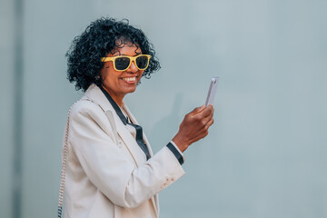 Wall Mural - middle-aged woman walking looking at mobile phone