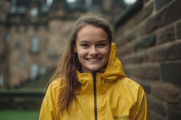 Medium shot portrait photography of a joyful girl in her 20s wearing a functional windbreaker at the edinburgh castle scotland. With generative AI technology