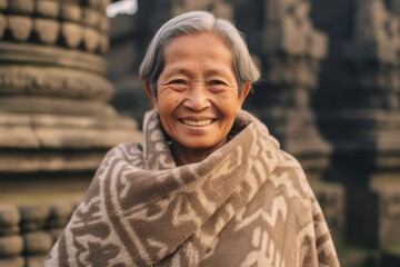 Wall Mural - Medium shot portrait photography of a joyful mature woman wearing a warm wool sweater at the borobudur temple in magelang indonesia. With generative AI technology