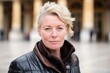 © Markus Schröder - Close-up portrait photography of a glad mature woman wearing a classic leather jacket at the palace of versailles in versailles france. With generative AI technology
