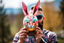 Cheerful Man With Festive Rabbit Mask In His Hands On Blurred Background