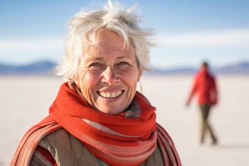 Headshot portrait photography of a merry mature woman wearing a classic turtleneck at the salar de uyuni in potosi bolivia. With generative AI technology