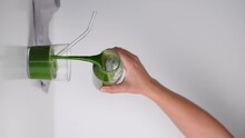 Pour The Green Juice From The Carafe Into A Glass Beaker