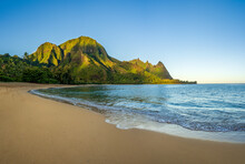 Aerial Panoramic Image Of Early Morning Light Just Catching The Mountains. Tunnels Beach On Hawaiian Island Of Kauai