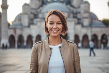 Wall Mural - Lifestyle portrait photography of a merry girl in her 30s wearing a stylish varsity jacket at the blue mosque in istanbul turkey. With generative AI technology