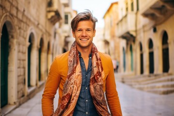 Canvas Print - Lifestyle portrait photography of a joyful boy in his 30s wearing a gorgeous silk scarf at the dubrovnik old town in dubrovnik croatia. With generative AI technology