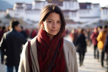 Wall Mural - Medium shot portrait photography of a glad girl in her 30s wearing a chic cardigan at the potala palace in lhasa tibet. With generative AI technology