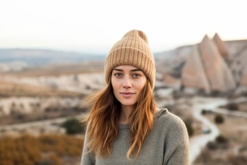 Canvas Print - Medium shot portrait photography of a satisfied girl in her 30s wearing a warm wool beanie at the cappadocia in nevsehir province turkey. With generative AI technology