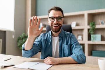 Aufkleber - Greeting Concept. Happy Young Businessman In Eyeglasses Waving Hand At Camera