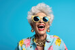 Woman wearing sunglasses and necklace is captured in moment of laughter. Joy, happiness, and carefree attitude. It is suitable for various marketing campaigns, lifestyle blogs, and social media posts.
