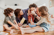 © Marko Geber - Young caucasian family being messy and having fun baking together in the kitchen