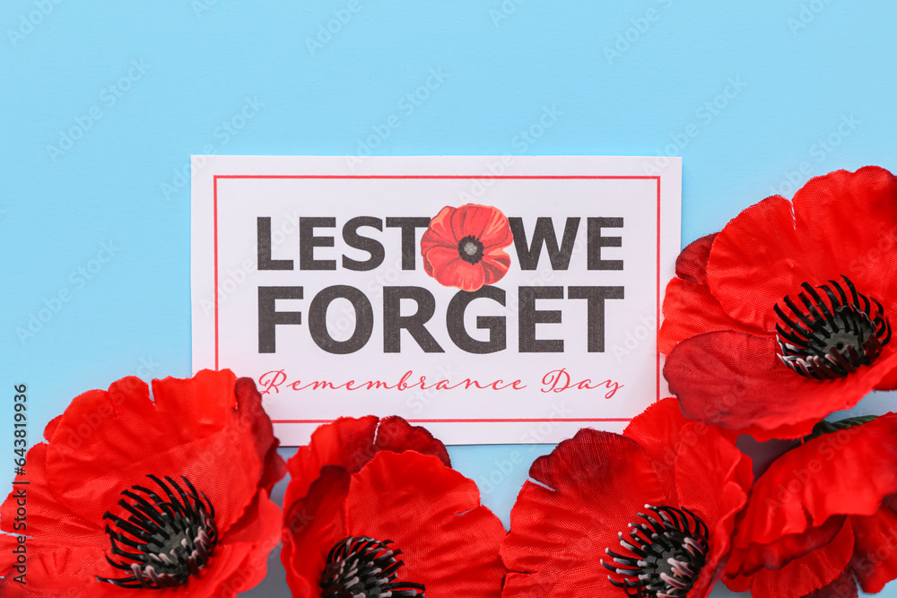 Red poppy flowers with card on blue background. Remembrance Day in Canada