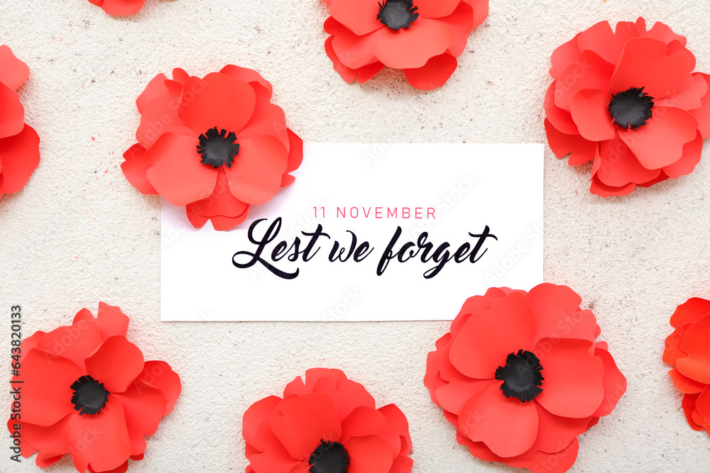 Red poppy flowers with card on grunge light background. Remembrance Day in Canada