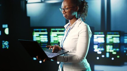 Poster - Focused IT consultant strolling through server rows providing processing resources for different workloads. Competent inspector overseeing supercomputers tasked with solving complex operations