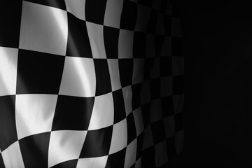 Checkered flag on black background, space for text