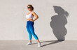 © Kaspars Grinvalds - Fit woman standing with her old body left in shadow. Concept of body transformation and weight loss through healthy diet and exercise.