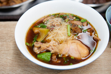 Rice vermicelli noodles with braised chicken meat in a bowl