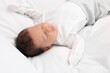 © New Africa - Cute newborn baby sleeping on white soft bed