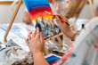 © Alfonso Soler - Painting Workshop. Closeup of woman hands painting.