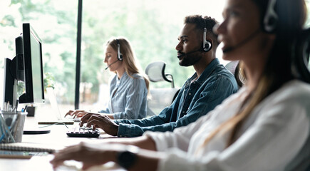 Wall Mural - Team of business people working in a call centre on the line.