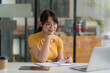 © amnaj - Young Asian Woman Studying with Laptop and Taking Notes for Online Learning