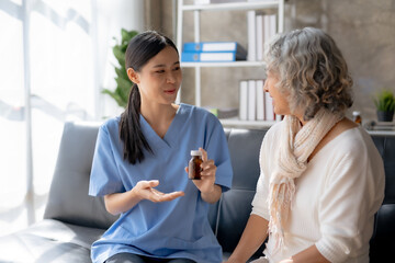 Wall Mural - Asian female doctor explaining treatment and taking medicine at home.