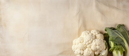 Poster - Fresh cauliflower on sackcloth background close up isolated pastel background Copy space
