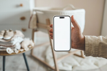 pregnant woman showing blank smartphone screen while resting on couch at home. expectant mom holding