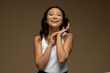 © WavebreakMediaMicro - Happy asian woman with dark hair touching hands