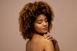 © WavebreakMediaMicro - Biracial woman with dark curly hair, touching shoulder with eyes closed