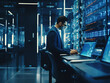 Successful data center IT specialist checking cloud servers while working as system administrator for cyber security.