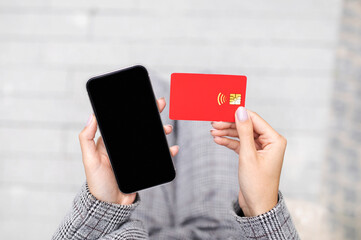 Poster - Closeup Of Credit Card And Smartphone In Businesswoman Hands Outdoor