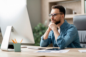 Aufkleber - Portrait Of Pensive Young Businessman In Eyeglasses Looking At Computer Screen