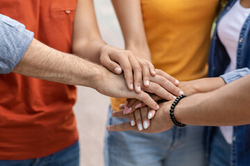 Wall Mural - Unity Concept. Group Of Unrecognizable Young People Joining Hands Together