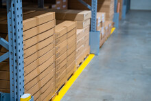  Long shelves with many cardboard boxes with product in warehouse of IKEA 