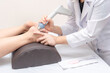 Physiotherapist close up helping woman heal feet; ankle inflammation