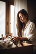 © OMD - shot of a young woman folding clothes at home