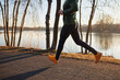 © baranq - Close up of a man running in park during sunny autumn winter afternoon