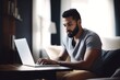 © Natalia - shot of a young man using his laptop while working from home