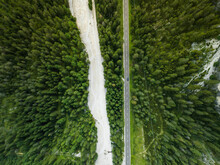 Aerial View Of Vehicles Driving On A Mountain Road With Forest Trees Near Landro Lake (Durrensee) On Dolomites Area, Upper Val Pusteria, Trentino, South Tyrol, Italy.