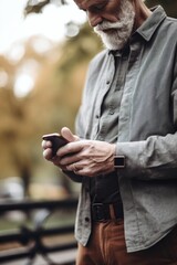 Poster - cropped shot of a man using his smartphone at city park