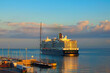 Huge luxury cruise ship arriving in port of Koper, Slovenia. Travel and tourism concept. Beautiful autumn morning sea landscape. Travel and tourism concept