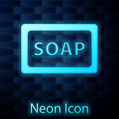 Poster - Glowing neon Bar of soap icon isolated on brick wall background. Soap bar with bubbles. Vector.