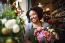 Happy Young Florist Smiling While Working In A Florist Shop. Young Small Business Female Owner Standing In Front Of Her Flower Shop.