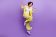 © deagreez - Full size photo of carefree overjoyed happy woman dance motion wear lime yellow flared outfit jumper isolated over purple color background