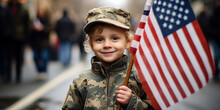 Child Holding US Flag, Stands Beside A Parade Route, In Military Uniform