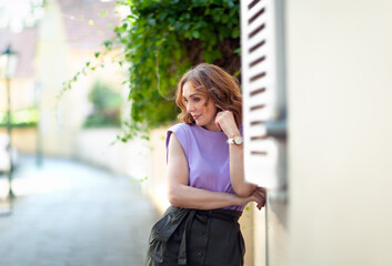 Wall Mural - Beautiful successful middle aged woman posing on the street photo shoot